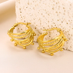 Detailed view of golden multi-layer beaded hoop earrings with twisted rope texture design