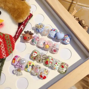 Macro shot of 3D Christmas nail art kit with reindeer, snowman and bow decorations