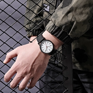 Outdoor sports watch with 24-hour scale and black nylon strap worn on wrist