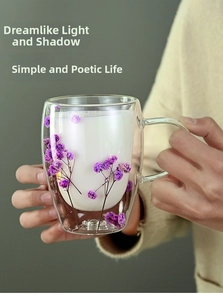 Detailed view of handmade double wall glass mug featuring embedded purple dried flowers
