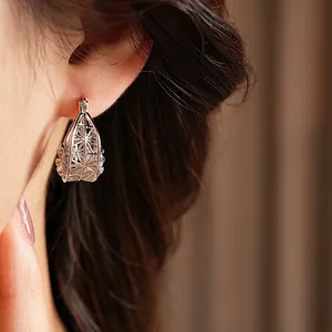Chic silver hollow flower hoop earrings in intricate woven geometric cage design