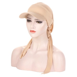 Detail of khaki turban sun hat featuring a curved baseball brim and long back ties