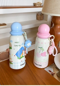 Detail of cute insulated mini cups with puppy and cherry designs plus floral charms