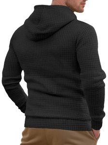 Close-up of the black waffle knit texture and fabric detail on this men's hooded sweatshirt