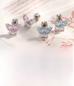 Macro shot of silver butterfly cartilage stud featuring pink and blue zircon stones