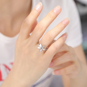 Minimalist silver stainless steel open ring with five-petal flower design on hand