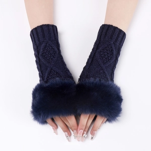 Detail of dark blue cable knit fingerless gloves with plush faux fur trim for winter