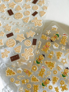 Detailed view of 3D embossed Christmas nail stickers with gingerbread men and tree motifs