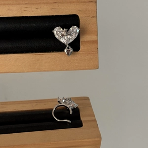 Detailed macro view of 18k gold plated heart zircon ear cuff with vintage cross