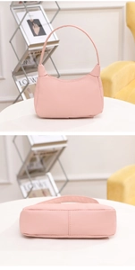 Close-up of pink lychee pattern leather texture and craftsmanship on a hobo bag