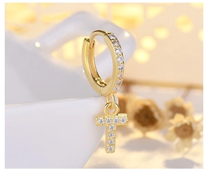Macro shot of gold letter T hoop earrings with micro-pave white cubic zirconia