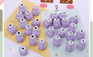 Flat lay of purple mini craft paper punchers with various number and shape patterns