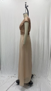 Detail of V-neck sequin bodice and chiffon skirt stitching on a champagne evening gown