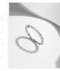 Macro detail of S925 silver irregular ring with sparkling stones on white geometry