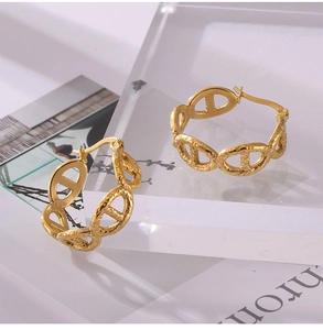 Detail of 18k gold plated stainless steel oval link earrings on acrylic stand