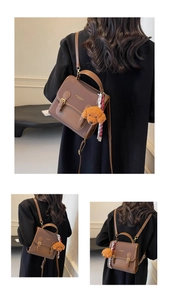 Close-up of brown leather backpack with teddy charm and silk scarf detail