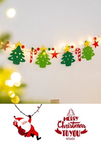 Detail of felt Christmas tree and star garland with warm LED lights on light wall