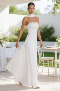 Elegant white strapless maxi dress with matching neck wrap in a sunny garden setting
