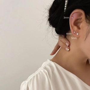Three sizes of 925 sterling silver cubic zirconia stud earrings shown on ear lobe