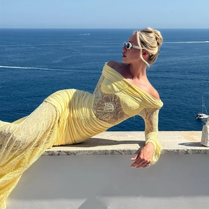 Detail of yellow lace splicing and pleated texture on this elegant off-shoulder maxi dress