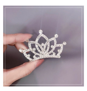 Close-up of a sparkling silver princess crown headband with white rhinestones