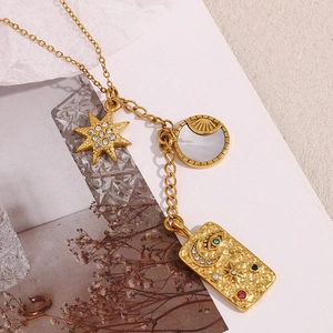Detailed close-up of 18K gold-plated tarot card pendant with moon, stars, and colorful gems