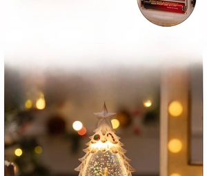 Detailed view of resin Christmas tree snow globe showing battery compartment for AAA cells