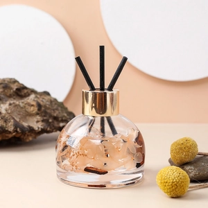 Car aromatherapy diffuser with preserved flowers and black reeds in a glass bottle
