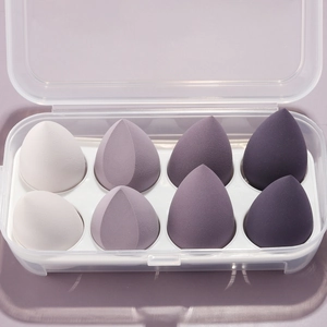 Detailed macro view of 8-piece purple gradient makeup sponge set in transparent case