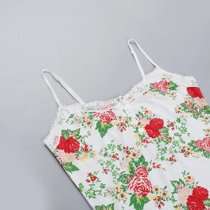 Detailed view of floral lace camisole with red roses and white decorative buttons