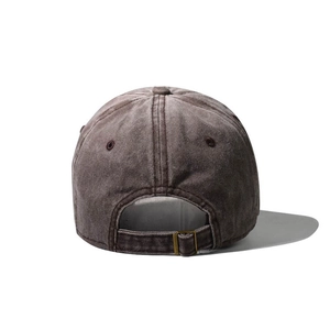 Detail view of washed cotton baseball cap with adjustable metal buckle and stitching