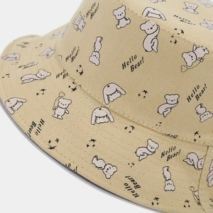 Detailed macro view of the beige canvas fabric featuring cute cartoon bear and rabbit prints