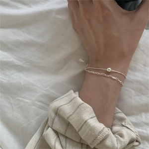 Close-up of a double-layered 925 sterling silver bracelet with beads on a wrist