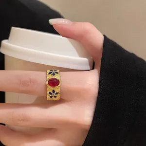 Detail of vintage s925 silver gold bamboo ring with red ruby and blue enamel floral