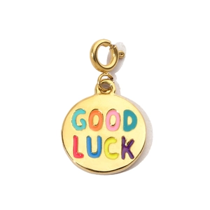 Close-up of gold stainless steel round pendant with colorful Good Luck text and clasp