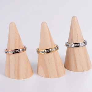 Eternity rings with zircon inlay in gold, rose gold and silver on wooden stands
