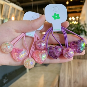Detail of pink and purple heart-shaped resin hair ties with high elasticity and sparkle finish