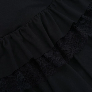 Detail of black lace texture and layered ruffle trim on the square neck mini dress