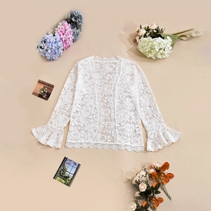 Detail of white crochet lace cardigan featuring flared sleeves and wavy scalloped edges