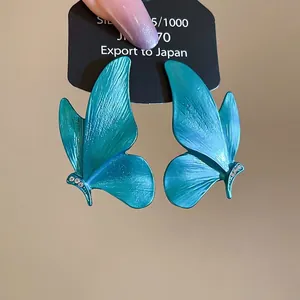 Luminous teal butterfly stud earrings with sparkling crystals on a 925 silver base