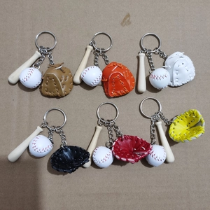 Detail of baseball keychain set with mini wooden bat and colorful leather gloves