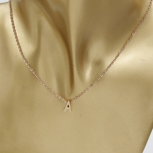 Close-up of rose gold letter A pendant necklace on o-chain for elegant women