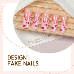 Long coffin fake nails with red heart patterns and French tips in a sweet style