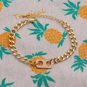 Adjustable gold-plated chain bracelet with rectangular zircon centerpiece on tropical fabric