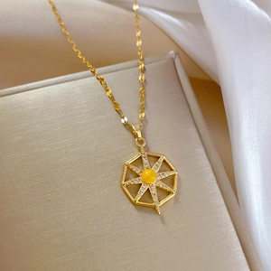 Macro shot of titanium steel starburst necklace with yellow gemstone and micro-pave crystals