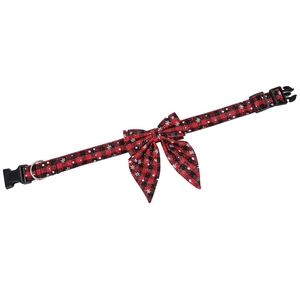 Detail of red and black plaid Christmas dog collar with white snowflake patterns