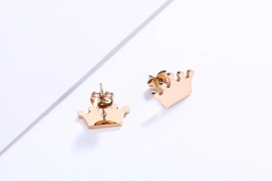 Detailed view of rose gold crown stud earrings with a polished finish and butterfly backs