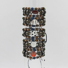 Detail view of five handmade woven leather bracelets featuring diverse sports ball charms