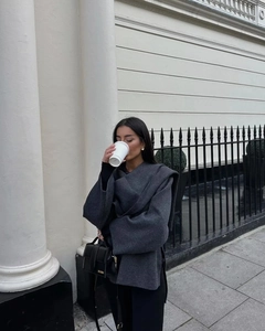 Close-up of thick dark grey wool scarf paired with a black leather designer handbag