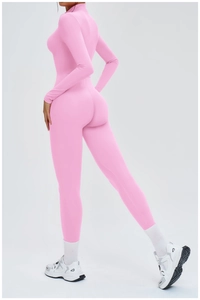 Detailed back view of pink long sleeve yoga jumpsuit showing high-stretch athletic fit